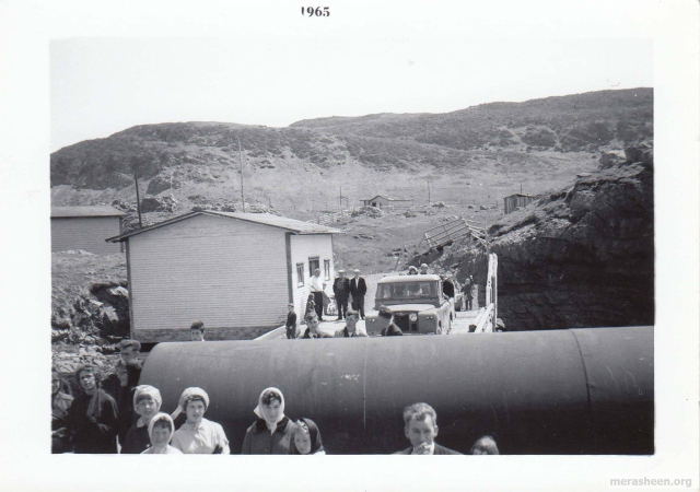 On the government wharf in 1965.&amp;nbsp; By the freight shed are Paddy Hann, Tommy Pittman and Harold Rose.&amp;nbsp; Father Power's jeep.&amp;nbsp; To the left of the fuel tank for the new power house is Andy Ennis and Betty Ennis.
