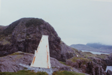 The Merasheen Lighthouse taken by Ernie Walsh in 1978 on the Western Head.&amp;nbsp; Donald Pittman and Roy Tuck (a visitor) are on the knob below.&amp;nbsp; Loyola Pomroy is in a dory just out of camera sight.&amp;nbsp; Mr. Pat Pomroy maintained the lighthouse in the 40's, 50's &amp;amp; 60's with the help of his sons Vince, Rod, Gabe and Gerard/Carter.&amp;nbsp; All required equipment would be brought to site by boat or dory and lugged up over steep rock cliffs and paths.&amp;nbsp; In the 50's the light house was painted red.&amp;nbsp; Paddy and Ray Hann painted it on a more recent occasion and they likely knew that it was not just about a face lift – there is much more beneath the painted surface of this landmark.&amp;nbsp; The lighthouse can be seen as a symbol of hope, a light amidst the dark of the stormy seas as it helps to guide those in need of sanctuary back to their homes. It tells us that that we may find ourselves in scary, rough and unknown sorrows and bad experiences but, there is a light, a symbolic beacon of hope at the end of this venture call life. Perhaps one day we hope it will shine again.