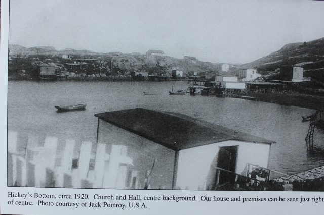 50 The Church in the far background and the caption on the photo identifies a Hall in 1920 which was later used as the Co-op store and the school remained on the second floor. John Louis Ennis’s, Ernie’s grandfather’s house and premises can be seen just to the right and centre. We can also see Canning’s Twine Loft in the foreground while it is Bernard Canning’s flake with fish drying at the bottom right corner; Martin Conner’s stage wharf is off to the left on Soldier’s Point. The two flakes and sheep house are on Mr. Pittman’s premises at the bottom centre of the inlet.